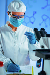 Wall Mural - Young scientist working in her lab