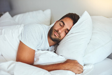 man, sleeping and bed in morning rest for healthy wellness, peace and quiet on comfort pillow at hom