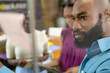 © Wavebreak Media - Closeup of african american businessman discussing with female colleagues seen through glass wall
