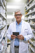 © Ruan J/peopleimages.com - Portrait, pharmacy and senior man on tablet for stock, inventory and medical information notes. Medicine, checklist and face of happy elderly male pharmacist online for pills and prescription