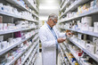 © Ruan J/peopleimages.com - Pharmacy, medicine and search with man at shelf in drug store for thinking, inspection and inventory. Medical, healthcare and pills with senior male pharmacist for expert, wellness and product