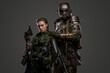 © Fxquadro - Shot of post apocalyptic people dressed in camouflage uniform against gray background.