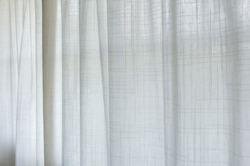 Wall Mural - A view of a sheer white curtain diffusing the exterior sunlight, as a background.