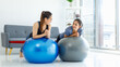 © Bangkok Click Studio - Two Asian beautiful healthy fit slim sexy female sporty athlete models friend in sports bra and leggings wearing using big exercise rubber yoga ball workout training stretching