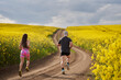 © Xalanx - Endurance runners on a dirt track in a canola field, training