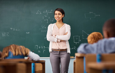 portrait, woman and teacher in a classroom, arms crossed and education with happiness, employment an