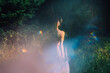 © irissca - Moments of stillness. moments of self-care and self-soothing. Healing rituals and meditation. Dance Movement Therapy. Young woman dancing in nature background with reflection