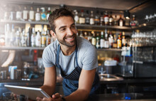 Smile, Thinking And A Barista With A Tablet At A Cafe For Online Orders And Communication. Happy, Ideas And A Male Pub Manager Or Bartender With Technology For An App, Connection And Ordering Stock