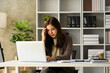 © Prathankarnpap - Upset asian businesswoman looking at laptop, frustrated about business failure in office