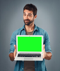 Poster - Man, laptop and portrait with mockup green screen for advertising or marketing against a grey studio background. Male person showing computer display, chromakey or mock up space for advertisement