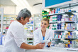 Pharmacist explaining medicine to a woman in the pharmacy for pharmaceutical healthcare prescription. Medical, counter and female chemist talking to a patient about medication in a clinic dispensary
