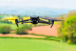 Drone in flight over fields and farms, Devon, England