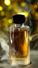 Vertical Video Of Glass Perfume Bottle Smoke Gold Bokeh