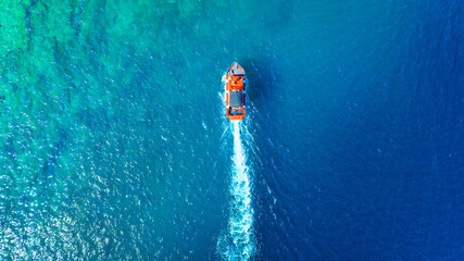 Wall Mural - wave and boat on the sea as a background. .reef and waves from top view. turquoise water background 