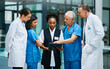 © Adene S/peopleimages.com - Planning, clipboard and medical with doctors in hospital for consulting, teamwork and communication. Medicine, healthcare and checklist with group of people for support, review and analysis