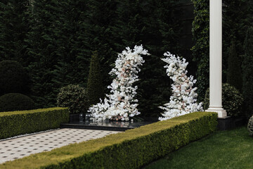 Wall Mural - Classic decor for wedding ceremony in the garden. The festive decor with white and rose floral arrangement.	