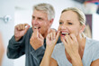 © Jadon Bester/peopleimages.com - Senior, couple and floss their teeth for fresh breath and a smile and healthcare at home. Elderly woman and man cleaning mouth for dental care in the bathroom for a healthy lifestyle and insurance.