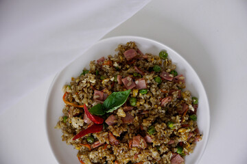 Wall Mural - Top view of a mixed fried rice plate in white background