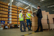 © visoot - Meeting at warehouse,Warehouse managers with warehouse workers have a briefing in a large distribution center,Concept of teamwork and occupation.