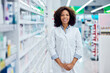 © bnenin - Portrait of a smiling African woman, posing for the camera, working at the pharmacy.
