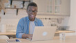 © stockbakers - Shocked Young African Man Working on Laptop