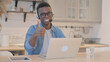 © stockbakers - Thumbs Up by Young African Man with Headset in Call Center