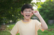 © lalalululala - Portrait of asian child wearing glasses smiling with nature background