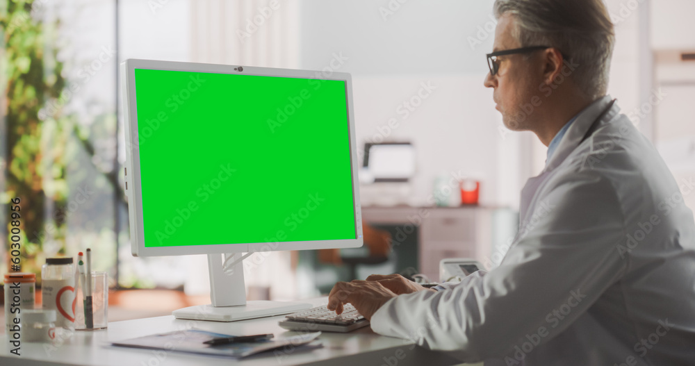 Healthcare Doctor Working on Desktop Computer with Green Screen Mock Up ...