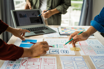 Wall Mural - group of asian creative team programing designers participate in all phases of the ux design.