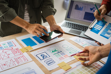 Wall Mural - group of asian creative team programing designers participate in all phases of the ux design.