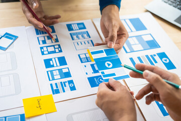 Wall Mural - group of asian creative team programing designers participate in all phases of the ux design.