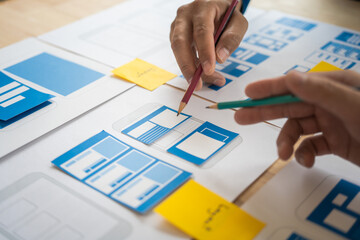 Wall Mural - group of asian creative team programing designers participate in all phases of the ux design.