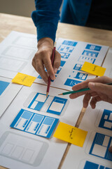 Wall Mural - group of asian creative team programing designers participate in all phases of the ux design.