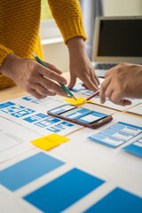 Wall Mural - group of asian creative team programing designers participate in all phases of the ux design.