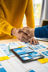 Wall Mural - shaking hands, group of asian creative team programing designers participate in all phases of the ux