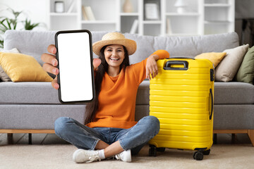 cheerful arab lady tourist showing smartphone with mockup