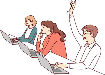 man student sitting at desk with laptop raises hand to ask question on topic of lecture