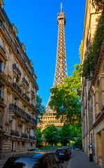 Wall Mural - view of eiffel tower and cozy street in paris, france. eiffel tower is one of the most iconic landma