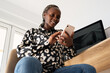 © Milles Studio/Stocksy - Smiling black woman browsing social media