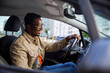 © Jovo Jovanovic/Stocksy - Happy man on driver seat controlling steering wheel of car
