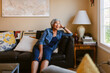 © ByLorena/Stocksy - Pensive senior woman relaxing at living room