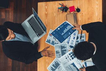 Poster - Top view analyst team discussing financial data on digital dashboard, analyzing chart and graph papers by data science software on wooden table background. Business intelligence and Fintech. Fervent
