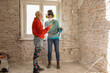 © Jelena Jojic Tomic/Stocksy - Handy girlfriends are renovating their apartment, checking their phone