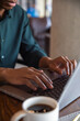 © Jovo Jovanovic/Stocksy - Male entrepreneur working on laptop at coffee shop