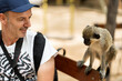 © Alvaro Lavin/Stocksy - smiling man next to a monkey in the wild