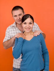 Poster - casual couple together standing on orange background