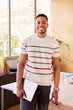 © ALTO IMAGES/Stocksy - Smiling African American man with laptop in office