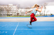 © Nibuya Qubik/Stocksy - Paralympic woman athlete with bionic leg prosthesis training sprints