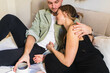 © Diego Martin/Stocksy - A couple laying on bed
