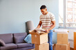 © ALTO IMAGES/Stocksy - Young African American man in casual clothes standing near sofa